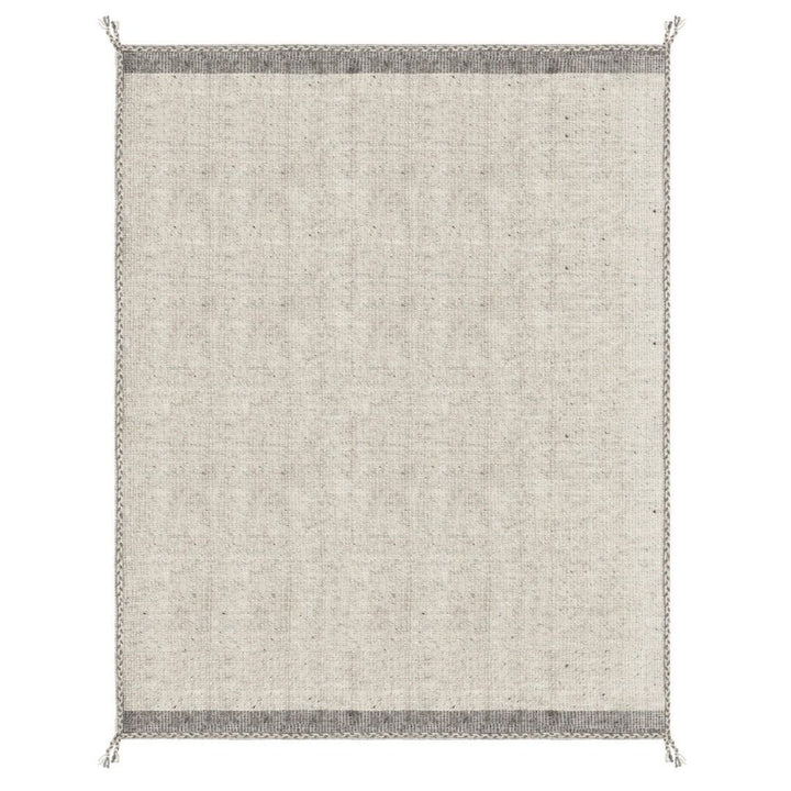 Tappeto Chathu beige in soggiorno moderno con libreria in legno

